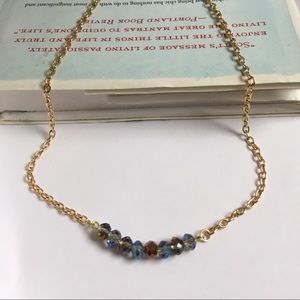 Faceted beaded necklace in gold finish.